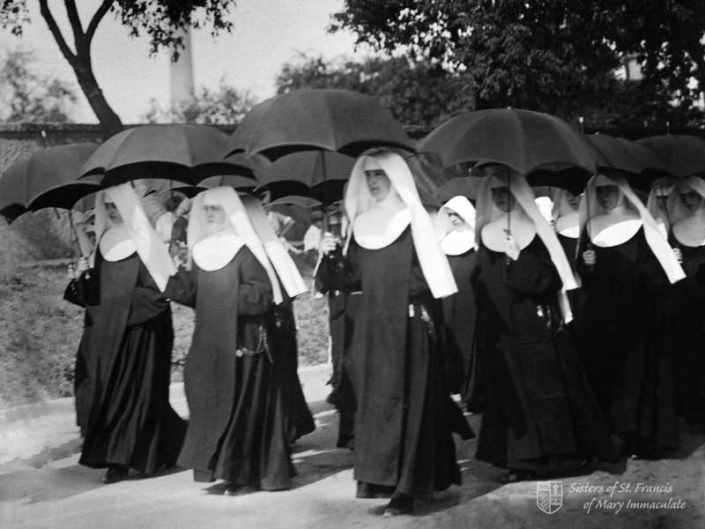 Sisters out walking with umbrellas